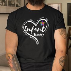 a man with tattoos on his arm wearing a t - shirt that says infant teacher