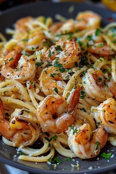 pasta with shrimp and parsley in a black bowl