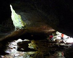 two people standing in the middle of a cave