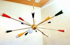 a chandelier hanging from the ceiling in a room with white walls and flooring