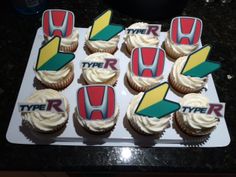 cupcakes with white frosting are arranged on a tray that says type r