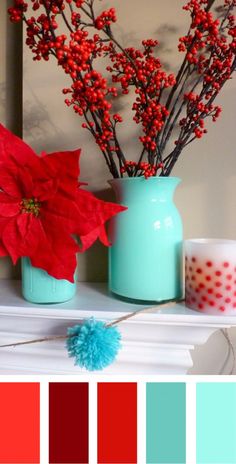 a vase filled with red flowers next to a candle and other items on a mantle