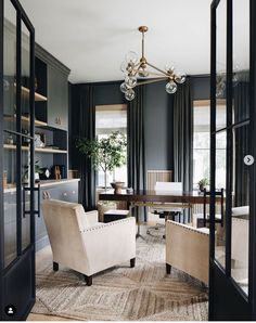 a living room filled with furniture and a chandelier