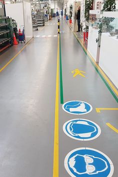 an indoor parking lot with several signs on the floor