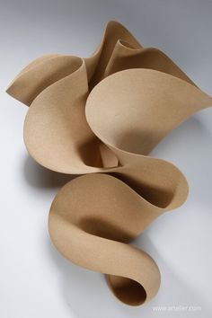 an abstract sculpture made out of clay on a white surface