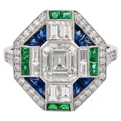 Three gems Art Deco ring by Sophia D. Set in platinum, the ring features a cushion cut center diamond that weighs approximately 1.15 carats with 0.09 carats emerald and 0.46 carats sapphires. The ring is a size 6.5 and is resizable and stamped with Sophia D. Sophia D by Joseph Dardashti LTD has been known worldwide for 35 years and are inspired by classic Art Deco design that merges with modern manufacturing techniques. Jewelry Design Inspiration, Gems Art, Vintage Style Rings, Deco Ring, Art Deco Ring, Art Deco Design, Cushion Cut, Classic Art, Ring Verlobung