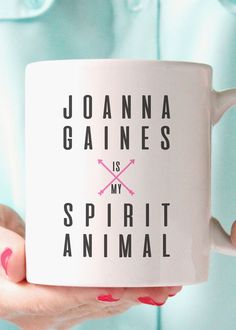 a woman holding a coffee mug with the words joanna garnes and spirit animal on it