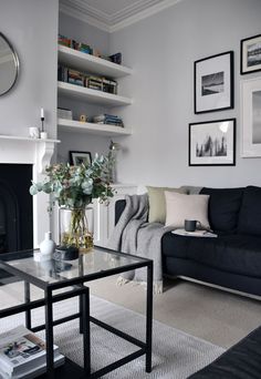 a living room filled with furniture and a fire place in front of a wall mounted mirror