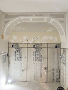 an unfinished room that has been painted white and is being worked on with the wallpaper