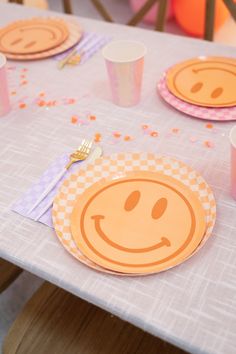 a table topped with plates and cups filled with confetti