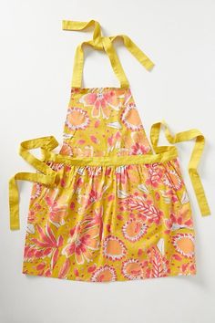 a yellow apron with pink and orange flowers on it