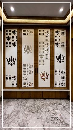 an empty room with decorative screens on the wall and marble flooring in front of it