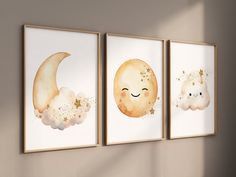 three watercolor paintings depicting the moon and cloud in different sizes, hanging on a wall