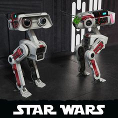 two star wars action figures standing next to each other in front of a black background