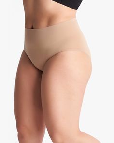 These hip-hugging briefs are crafted from a compression material that gives you an all-day held-in feeling. Their seamless construction makes them ideal to wear under denim, trousers, and skirts alike. These plus-size shapewear briefs are as supportive as they are stylish. Yummie Seamless Brief | Brown | Intimates | Materials & Care Instructions: 81% Nylon, 19% Spandex, Hand wash Compressive Shapewear Bottoms With Built-in Bra, Stretch Shapewear Brief With Built-in Bra, Stretch Shapewear Briefs With Built-in Bra, Stretch Shapewear With Built-in Bra Briefs, Versatile Seamless Shapewear, Stretch Full Coverage Shapewear Bottoms, Full Coverage Stretch Shapewear Bottoms, Stretch Brief-style Shapewear Bottoms, Elegant Supportive Solid Bottoms