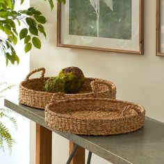 two wicker baskets sitting on top of a table