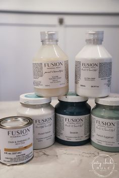 several different types of paint sitting on top of a counter