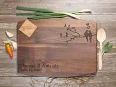 a wooden cutting board with two birds on it