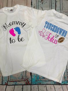 two t - shirts that say mommy, football and footy to be on them