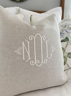 the monogrammed pillow is made from linen and has an embroidered initial on it