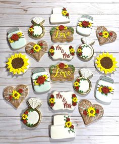 decorated cookies arranged in the shape of hearts and sunflowers on a wooden table