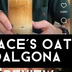 a man holding a tall glass with liquid in it and the text space's oat dalgona review