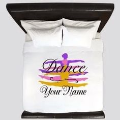 a bed with a white comforter and two pillows on top of it that says dance your name