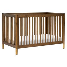 a wooden crib with white sheets on the bottom and one bed in the middle