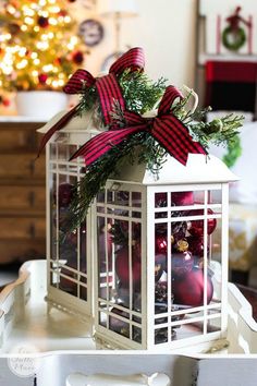 a lantern filled with ornaments on top of a table