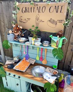 an outdoor buffet with various items on it and a sign that says the gruffalo cafe