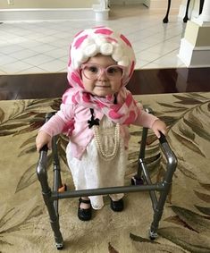 an old lady doll sitting in a walker