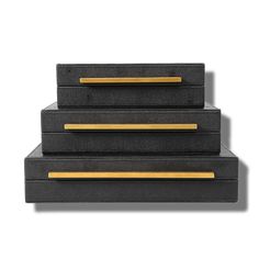 three black and gold boxes stacked on top of each other