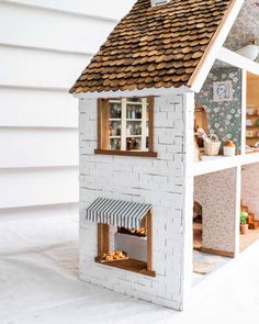 a doll house made out of white bricks