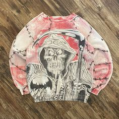 a long sleeved shirt with an image of a skeleton wearing a hat and holding a knife