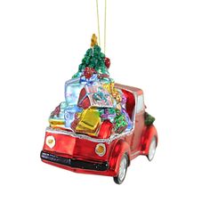 an ornament shaped like a red truck with a christmas tree on the back