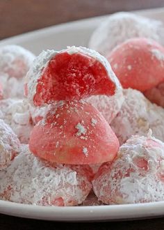 powdered sugar covered pastries on a white plate