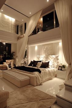 a large bed sitting in the middle of a bedroom next to a white couch and chair