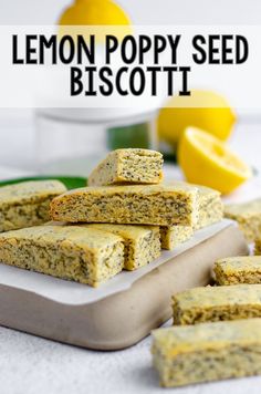 lemon poppy seed biscotti on a plate with lemons in the background