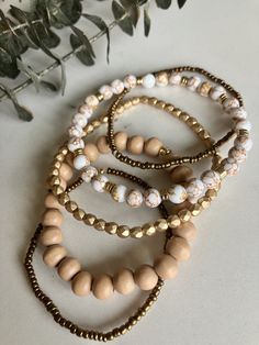 Dress up your outfit with these beautiful boho stack bracelets, with neutral wood, gold, white/gold howlite stone, and brass tones.  They are made with elastic string and have a slight stretch, but are still delicate and best to roll on/off individually when putting on and removing.  PLEASE MEASURE YOUR WRIST BEFORE ORDERING!  Add 1/2 inch for a more snug fit or 3/4 to 1 inch for a loose fit. Due to differences in screen resolution colors, beading colors may vary slightly.  Care instructions: -remove while active -remove when showering  -let lotions/perfumes dry before wearing -remove when sleeping -store in a sealable container for added protection from air/moisture, which helps prevent tarnishing Please message me with any questions! Thanks for stopping by! Neutral Bracelet, Stretch Beaded Bracelets Diy, Neutral Bracelets, Boho Bracelets Stack, Layering Bracelets, Neutral Jewelry, Stack Bracelets, Howlite Stone, Bracelets Gold