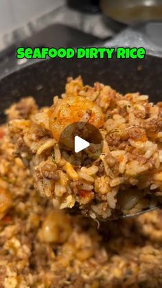 the food is being cooked and served in a skillet with a ladle full of rice