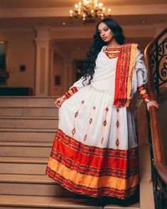 This exquisite Ethiopian Habesha dress is a true masterpiece of traditional craftsmanship. The lower part of the dress is made of Shimena, which is handwoven with great care and attention to detail, resulting in a beautiful and unique texture. The Menen fabric used in this dress is of the highest quality, adding a luxurious feel to the overall design. The neckline and wrists of the dress are adorned with intricate Tilf embroidery, adding an elegant and sophisticated touch to the vibrant colors o Traditional Drape Dresses With Woven Motifs For Eid, Eid Traditional Drape Handloom Dress, Eid Dresses With Traditional Drape And Woven Motifs, Ceremonial Dresses For Diwali With Traditional Drape, Eid Handloom Traditional Drape Dress, Ceremonial Dresses For Diwali, Traditional Floor-length Handloom Dresses, Ceremonial Handloom Dress For Festivals, Anarkali Dress With Woven Motifs For Traditional Ceremonies