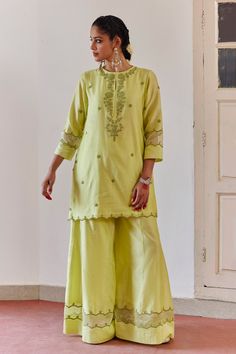 Green kurta with tonal cord embroidery on a neckline, sleeves and hem. Paired with wide legged embroidered sharara and embroidered dupatta.
Components: 3
Pattern: Embroidered
Type Of Work: Floral
Neckline: Round
Sleeve Type: Three quarter
Fabric: Chanderi Silk / Silk Organza
Color: Green
Other Details: 
Sheer panel detailing
Cutwork detailing
Side slits
Occasion: Puja - Aza Fashions Raw Silk Sets With Cutdana For Eid, Unstitched Pista Green Sets With Gota Work, Pista Green Sharara With Dori Work And Straight Kurta, Unstitched Sets With Cutdana For Eid, Pista Green Palazzo Set With Chikankari Embroidery For Wedding, Pista Green Chikankari Embroidery Palazzo Set In Slub Silk, Pista Green Slub Silk Set With Resham Embroidery, Wedding Pista Green Chikankari Palazzo Set, Wedding Pista Green Palazzo Set With Chikankari Embroidery