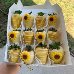 a box filled with chocolate covered strawberries and sunflowers on top of each other