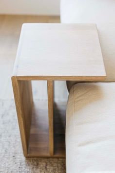 a wooden table sitting on top of a white couch