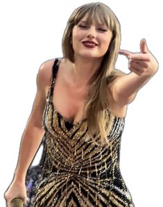 a woman in a gold and black dress pointing to the side with her finger up