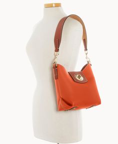 Casual Cool This gorgeous new look features classic Italian pebble leather and a jewelry grade turnlock closure, for a one of a kind look. One inside zip pocket. Two inside slip pockets. Inside key hook. Removable strap. Lined. Feet. Turnlock closure. | Dooney & Bourke Women's Pebble Turnlock Sac 22 Leather Shoulder Bag in Coral Elegant Pebbled Leather Shoulder Bag With Metal Hardware, Elegant Pebbled Leather Bag With Turn-lock Closure, Elegant Leather Satchel With Snap Closure, Pebbled Leather Shoulder Bag With Metal Hardware For Everyday, Elegant Everyday Satchel With Snap Closure, Key Hook, Satchel Tote, Wristlet Clutch, Dooney And Bourke