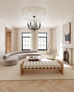 an elegant living room with white furniture and chandelier