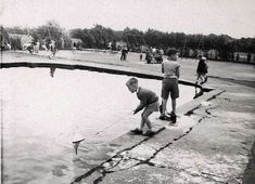 black and white photograph of children playing in water