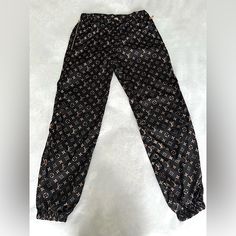 New Like Condition Lv Monogram Jogger Pants From The “Wild At Heart Collection” That Are Currently Sold Out In This Rare Color Combo. Size Eu36 Equivalent To Us4. Worn Very Gently A Handful Of Times, No Visible Signs Of Wear Present. Will Include Dust Bag. Product Details: Regular Fit. Hook Closure, Elasticated Ankles And Waist, And Two Zipped Pockets On The Sides. One Pocket In The Back. Luxury Black Bottoms With Pockets, Luxury Brown Pants, Luxury Black Leather Pants, Luxury Black Trousers, Louis Vuitton Pants, Wild At Heart, Lv Monogram, Jogging Pants, Wild Hearts