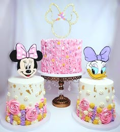 there are three cakes decorated to look like minnie and mickey mouses heads on top